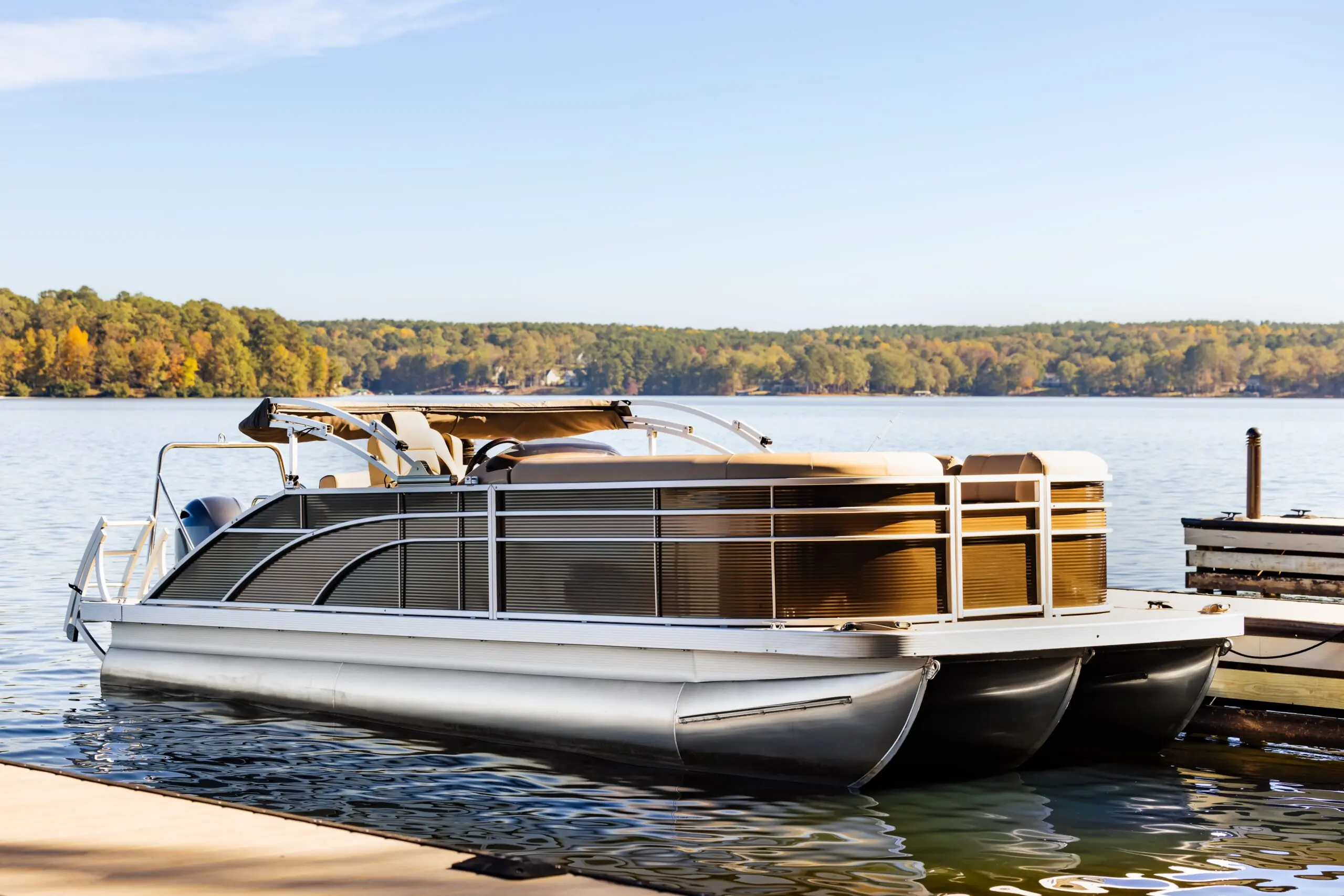 Pontoon boat at private marina dock on freshwater lake