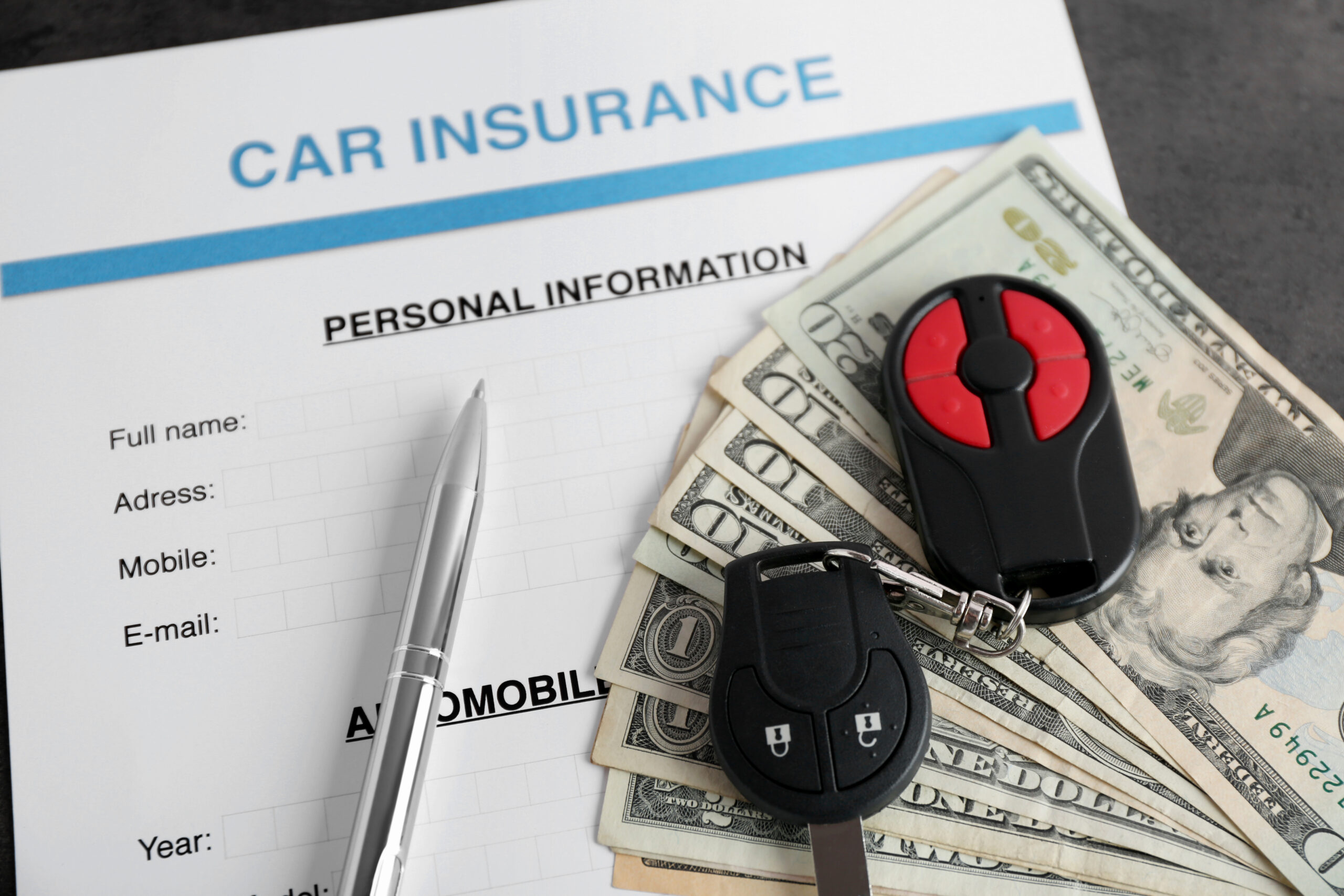 Car insurance form and money on table