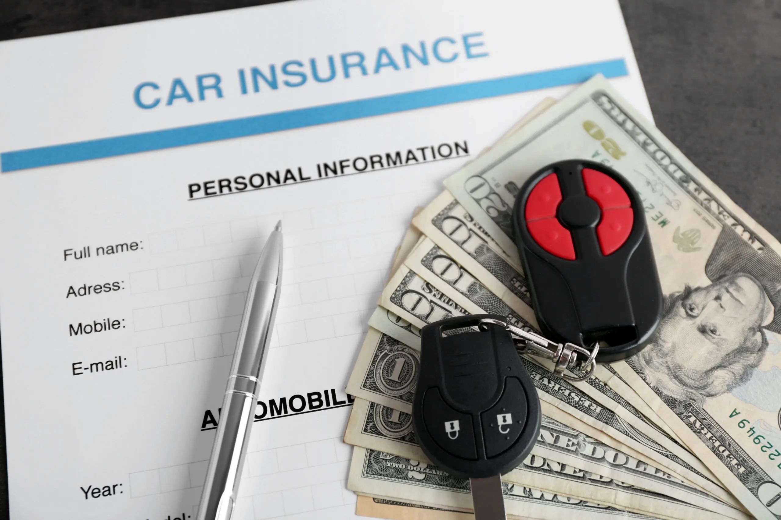 Car insurance form and money on table