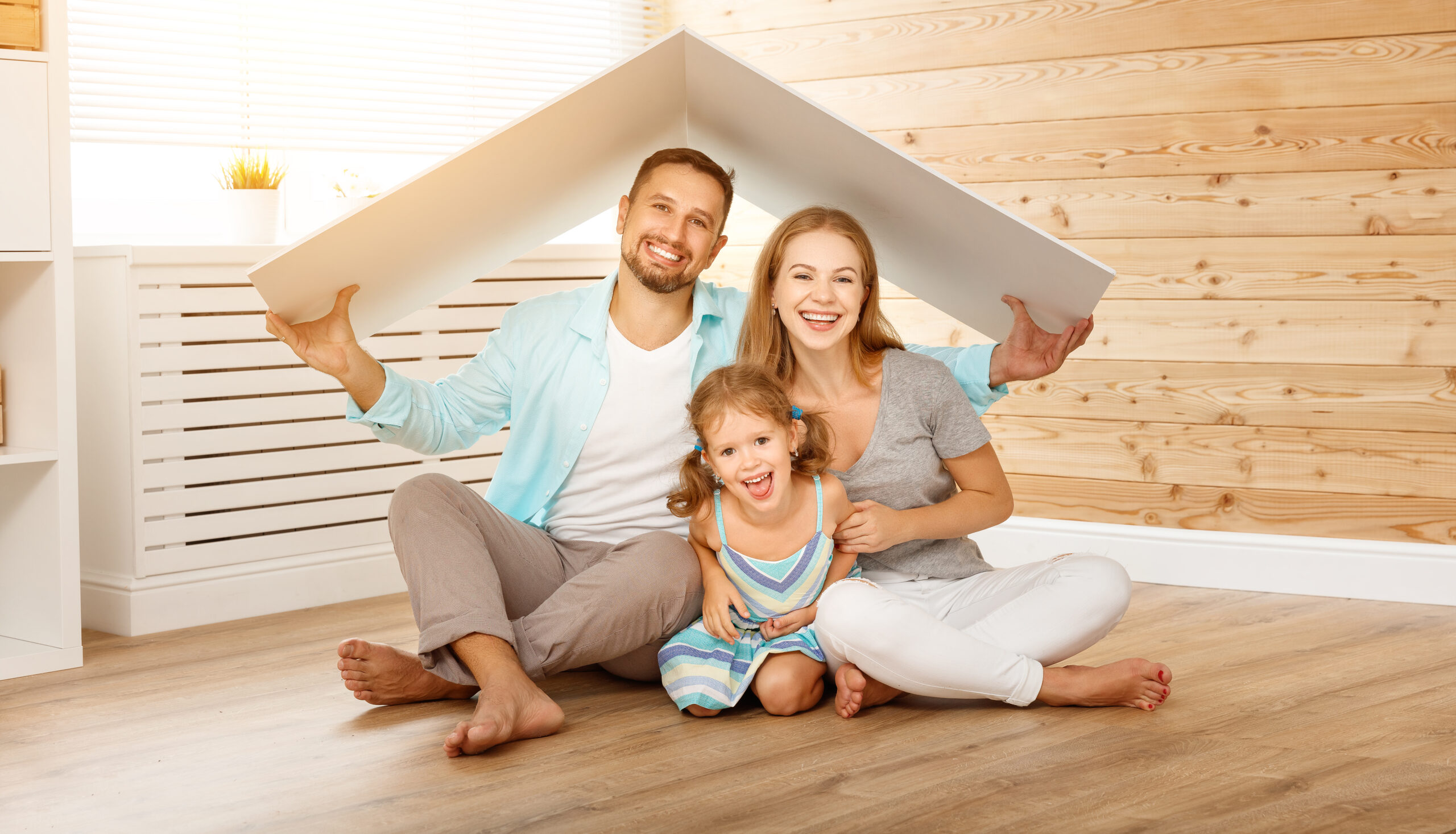concept housing a young family. Mother father and child in new house with a roof