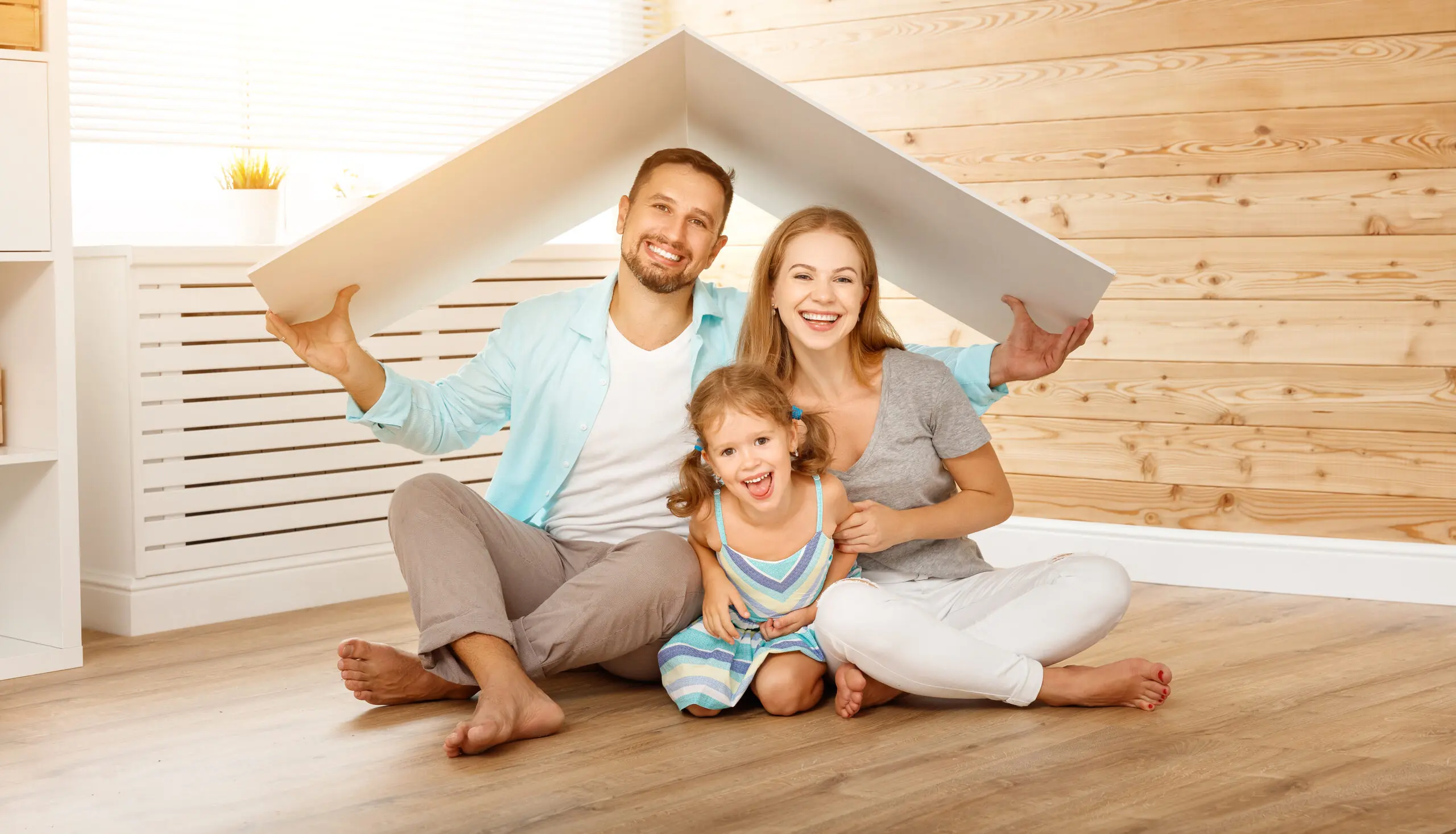 concept housing a young family. Mother father and child in new house with a roof