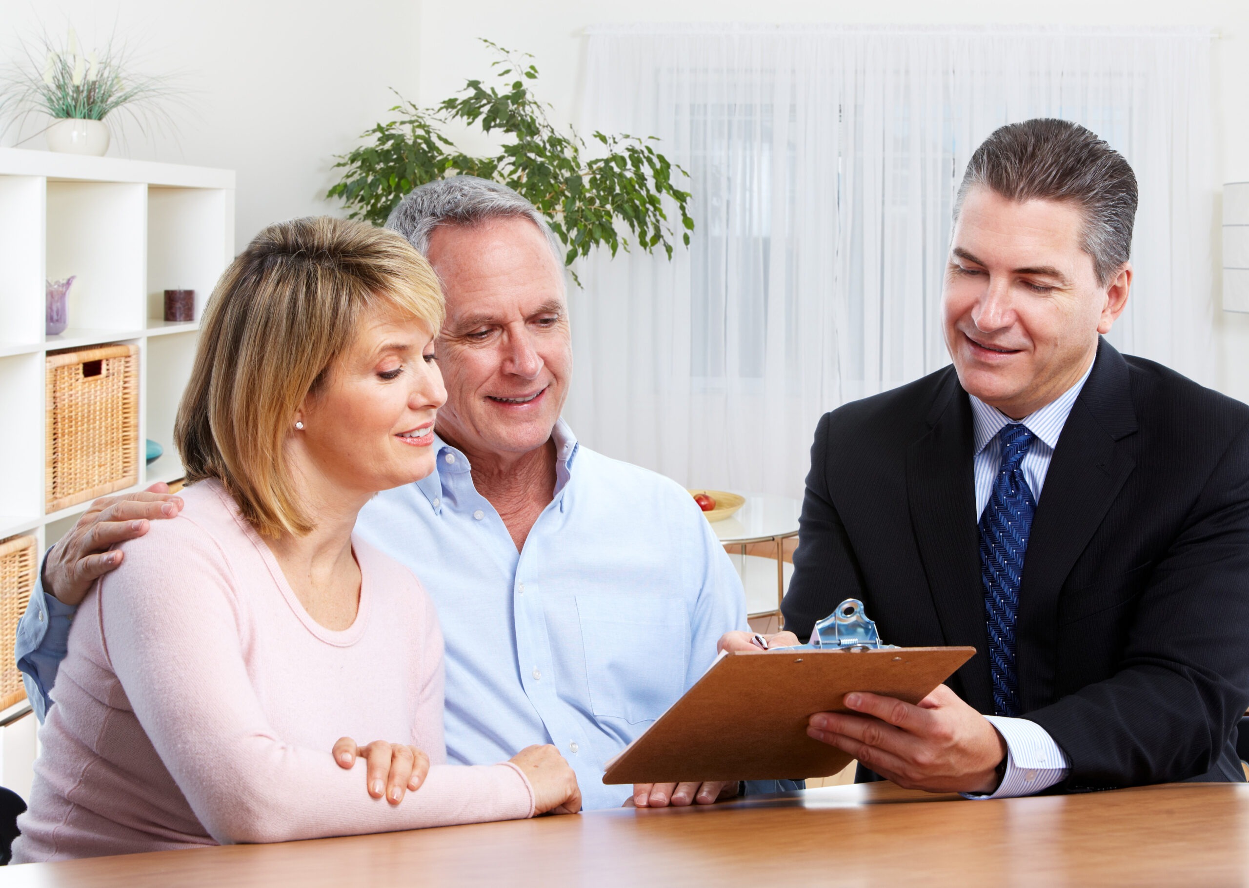 Senior couple with real estate agent in modern apartment.; Shutterstock ID 337719869; purchase_order: Pro Serv; job: ; client: ; other: